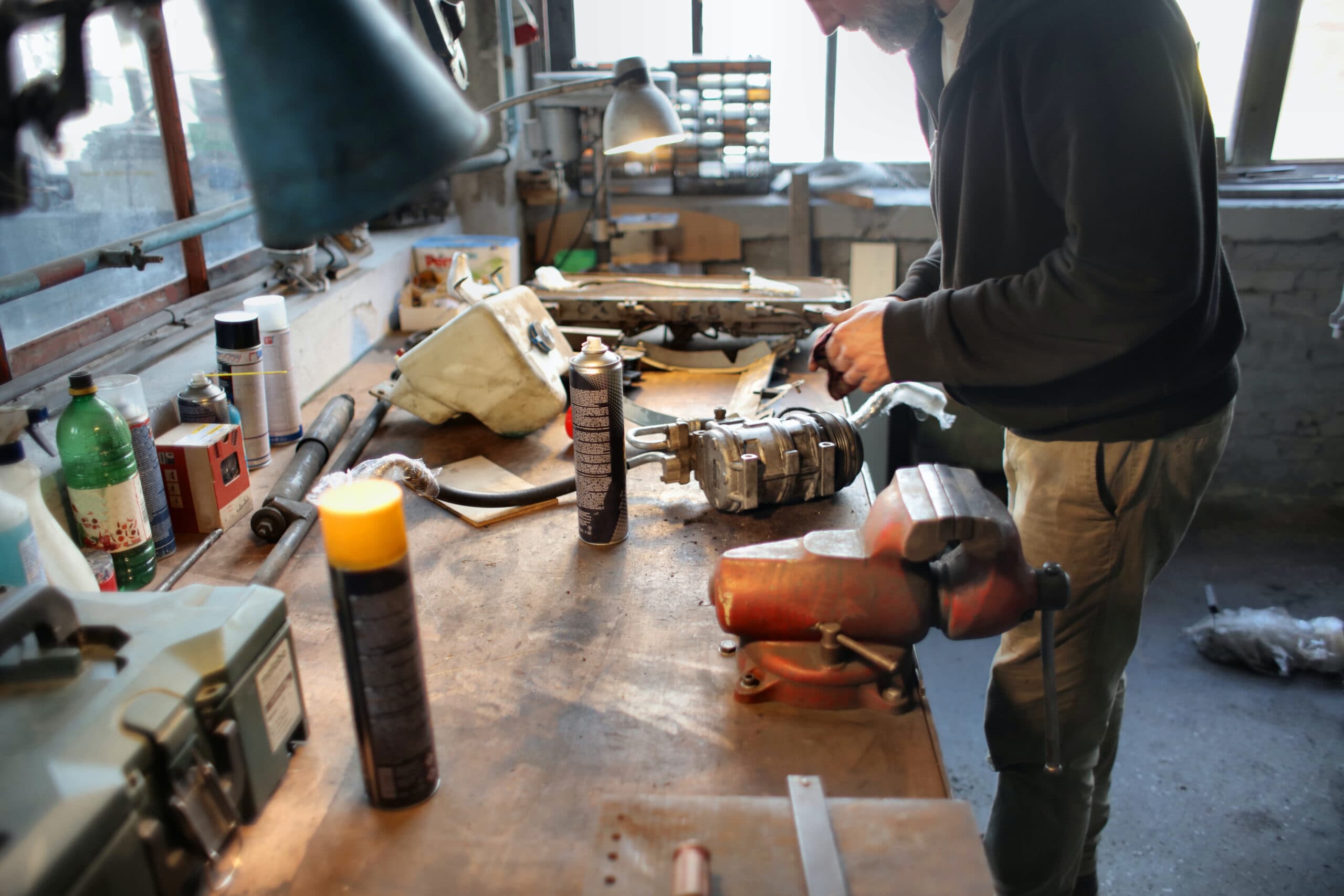 person fixing a part on a workbench